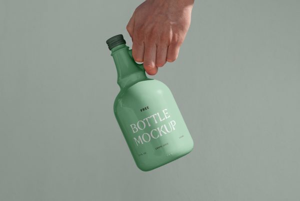 Men holding a green ceramic bottle mockup in front of the green wall.