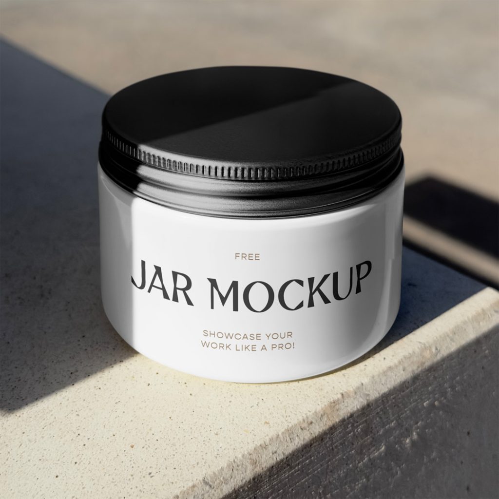 Front view, jar mockup with black lid laying on the concrete floor.
