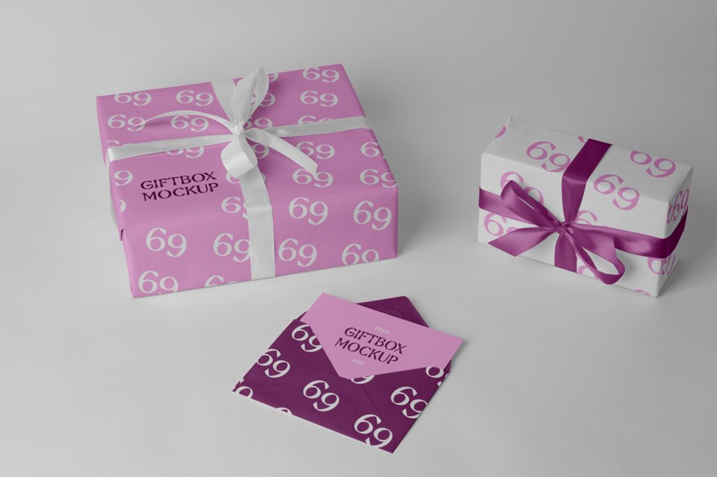 Pink envelope and gift boxes mockup with ribbon laying on the gray floor.