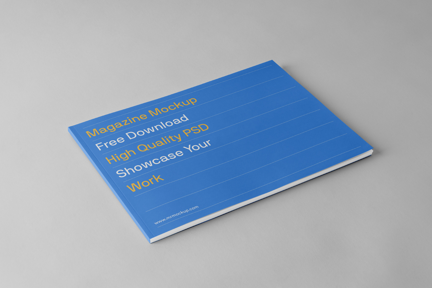 Blue horizontal magazine mockup laying on the gray floor.