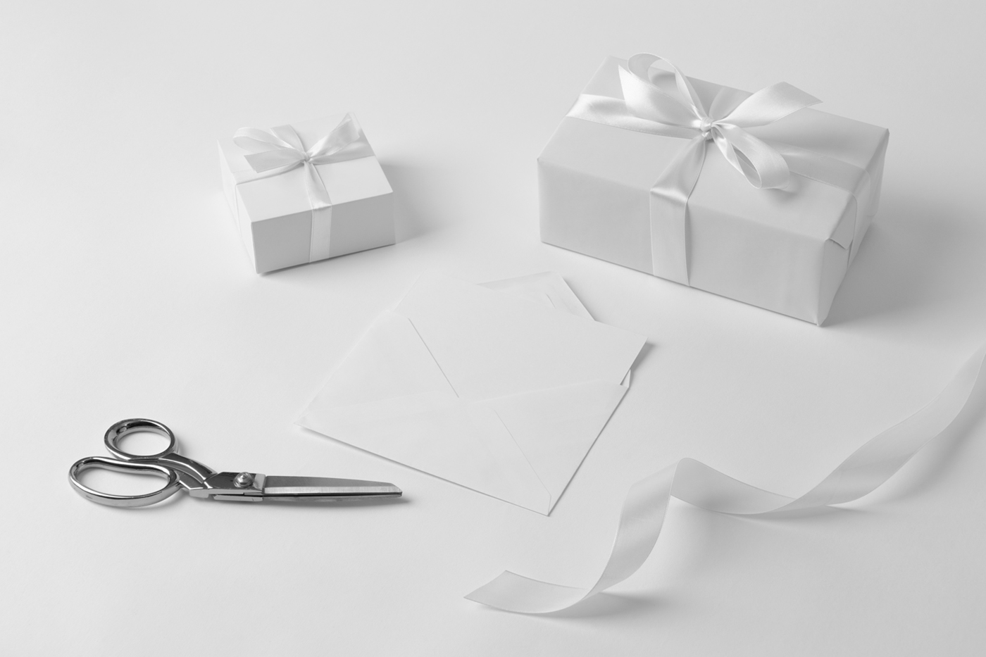 White color luxury gift boxes mockup laying on the white floor.