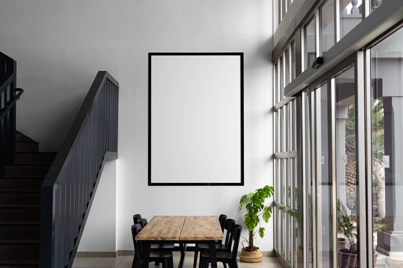 Front view, white poster mockup with black frame hanging on the white wall inside the flat.