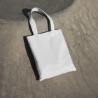 Canvas bag laying on concrete ground from outdoor apparel mockups vol.2.