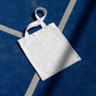 Canvas bag laying on blue court from outdoor apparel mockups vol.2.