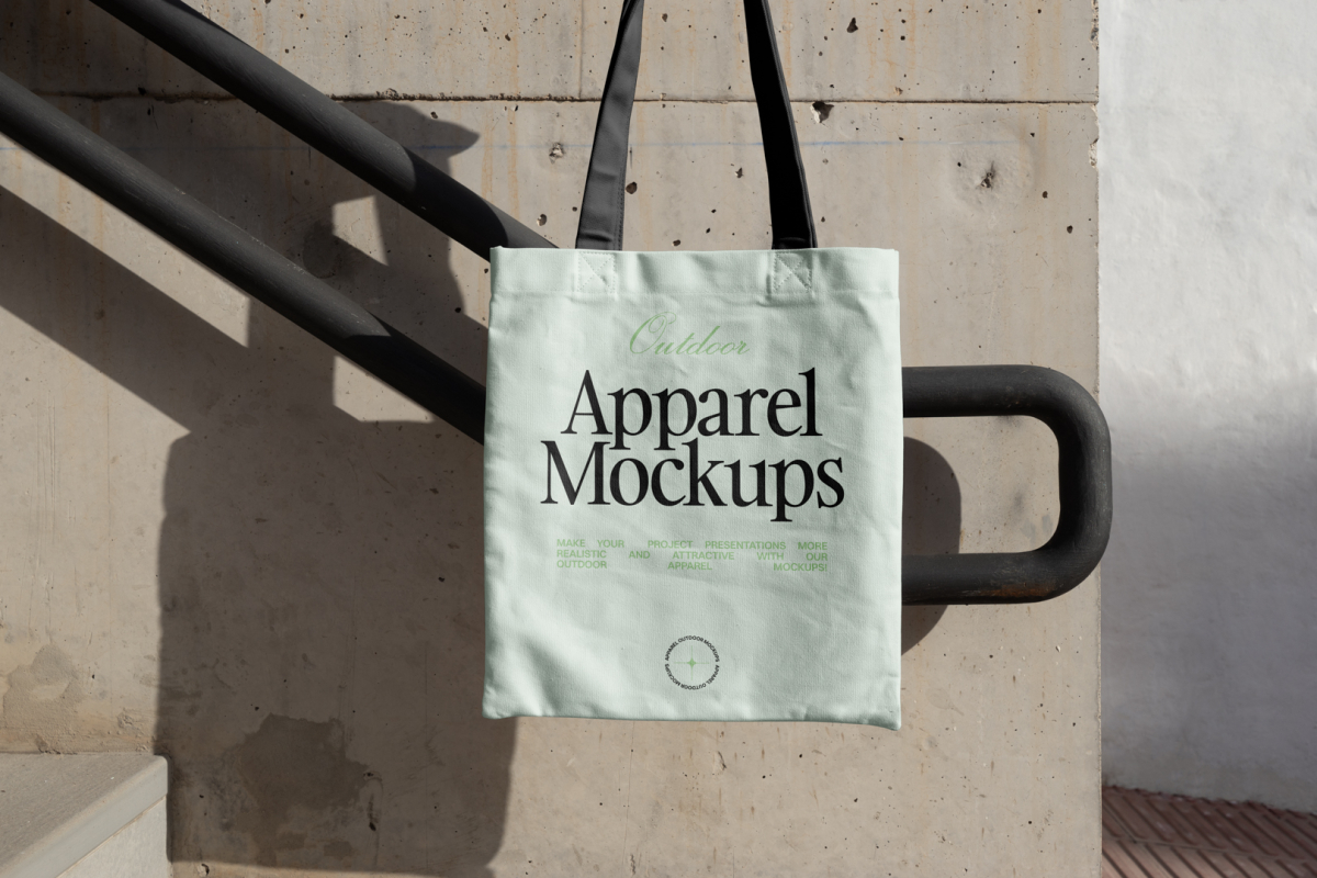 Green canvas bag with black handle hanging in front of handrail.