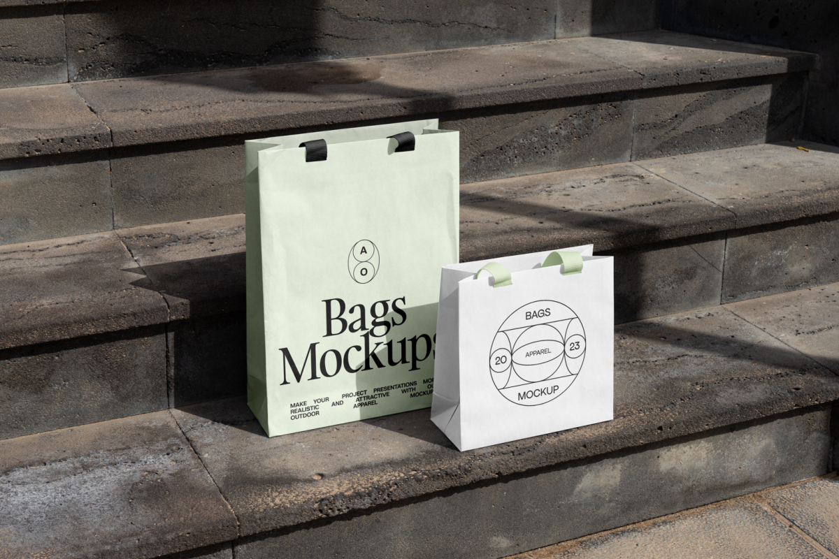 Two paper bags with typographic design on the big concrete stairs.