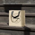 Small yellow paper bag with black handle on the concrete stairs.