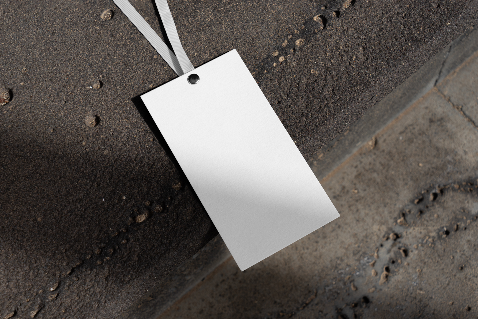 Paper tag laying on concrete stairs from outdoor apparel mockups vol.2.