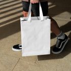 Man holding big paper bag from outdoor apparel mockups vol.2.