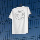 White t-shirt with black typographic design hanging on the metal fence.