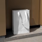 Paper bag in front of brown wall from outdoor apparel mockups vol.2.