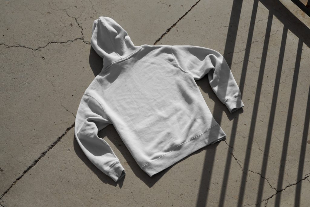 Hoodie laying on concrete floor from outdoor apparel mockups vol.2.