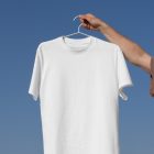 Man holding white t-shirt form outdoor apparel mockups vol.2.