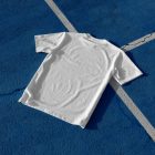 White t-shirt laying on blue basketball court form outdoor apparel mockups vol.2.