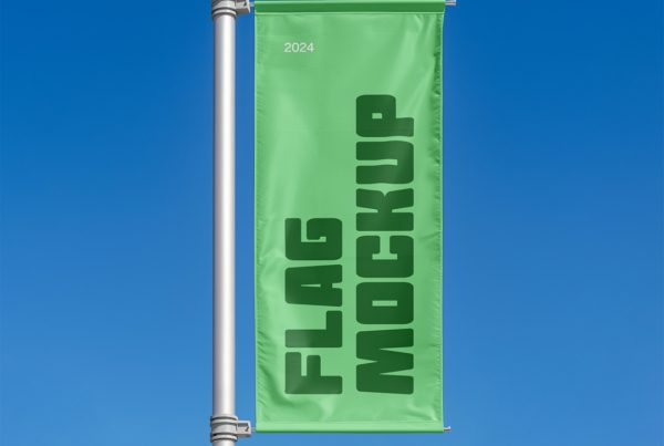 Front view, green vertical flag mockup with a visible sky behind.