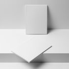 Two a4 blank magazines on white stairs from studio magazine mockups.