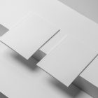 Two a4 white magazines on white cube from studio magazine mockups.