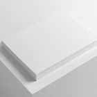 Three blank magazine laying on each other on white cube from studio magazine mockups.