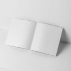 Open white square magazine on white cubes from studio magazine mockups.
