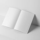 Open white a4 magazine on white cubes from studio magazine mockups.