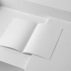 Open white a4 magazine on white cubes from studio magazine mockups.