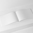 Open white horizontal magazine on white cubes from studio magazine mockups.