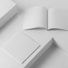 Two square white magazines on white cubes from studio magazine mockups.