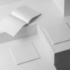 Three square white magazines on white cubes from studio magazine mockups.