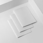 Three a4 blank magazines on white cubes from studio magazine mockups.