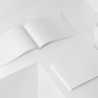 Two horizontal white magazines on white cubes from studio magazine mockups.