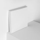 Three square white magazines on white cube from studio magazine mockups.