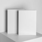 Two a4 blank magazines on white cube from studio magazine mockups.