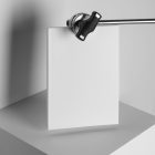 White a4 magazine hanging on tripod from studio magazine mockups.