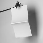 White cover square magazine hanging on tripod from studio magazine mockups.