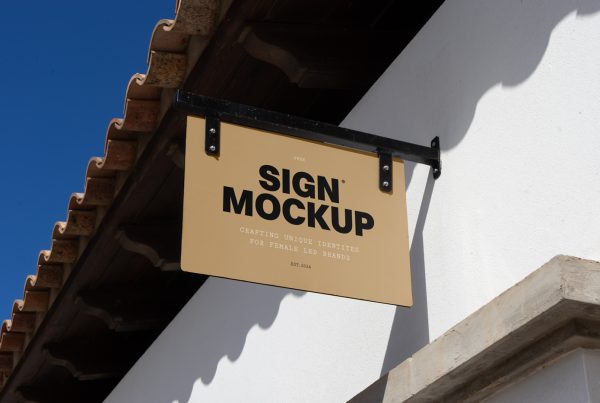 Front view, sign mockup attached to black metal construction hanging in front of the buildings.