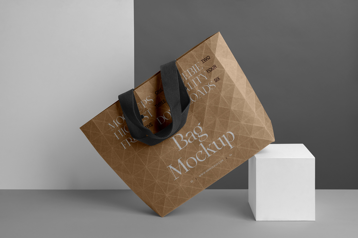 Gold big paper shopping bag mockup with black handle, based on the white box in front of the black and white wall.