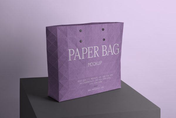 Purple big paper shopping bag mockup standing on the black box in front of the pink wall.