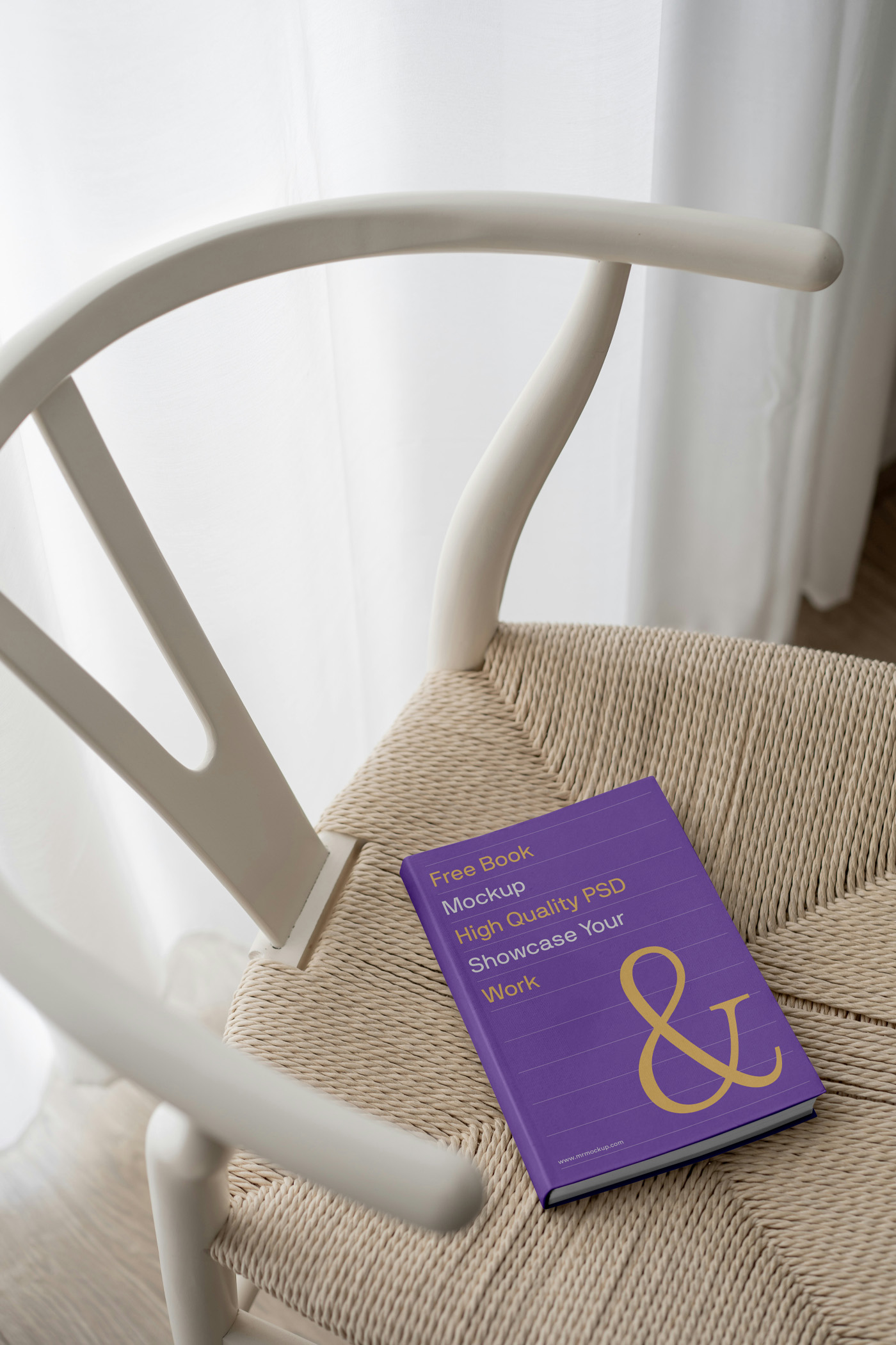 View from above, hardcover book mockup laying on the chair inside the flat.