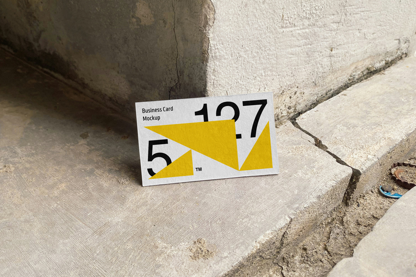 Front view, business card based on the wall corner and standing on the concrete floor.