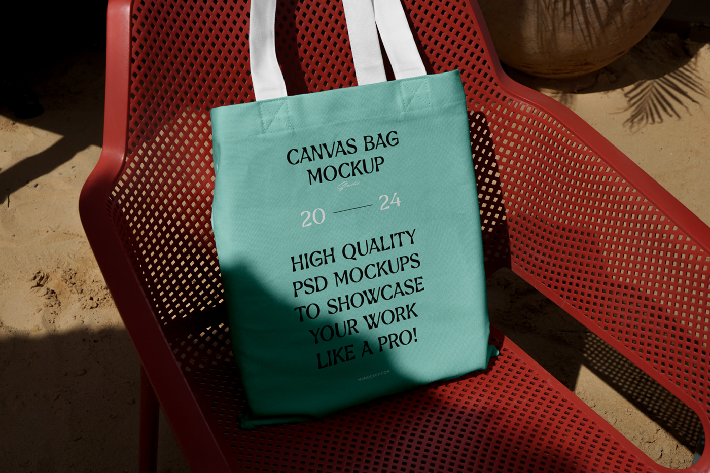 Front view, canvas bag laying on the red plastic chair.