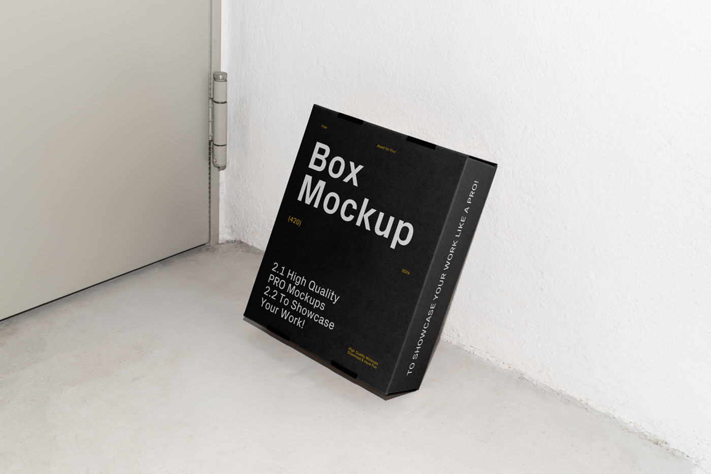 Front view, of a black cardboard box mockup with white strong typography design based on a white wall and standing on the concrete floor.