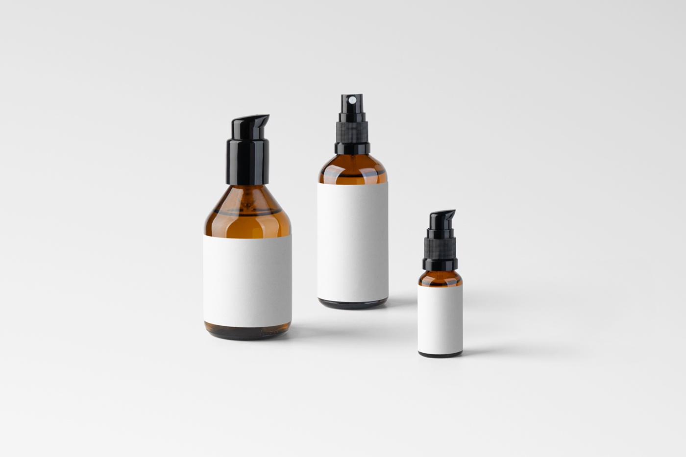 Front view, three cosmetics packaging bottle mockup with white labels standing on the white floor.
