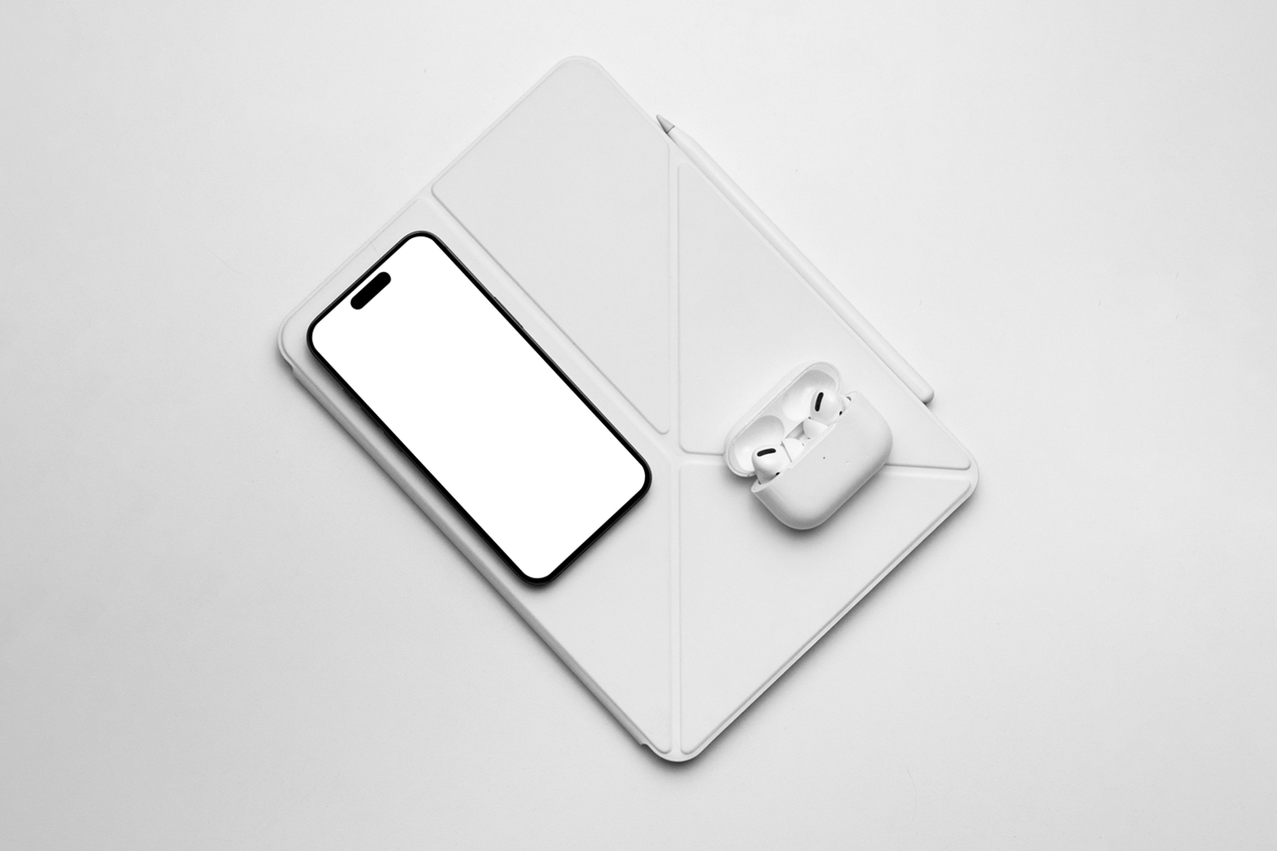 View from above, white device with accessories mockup laying on the white floor.