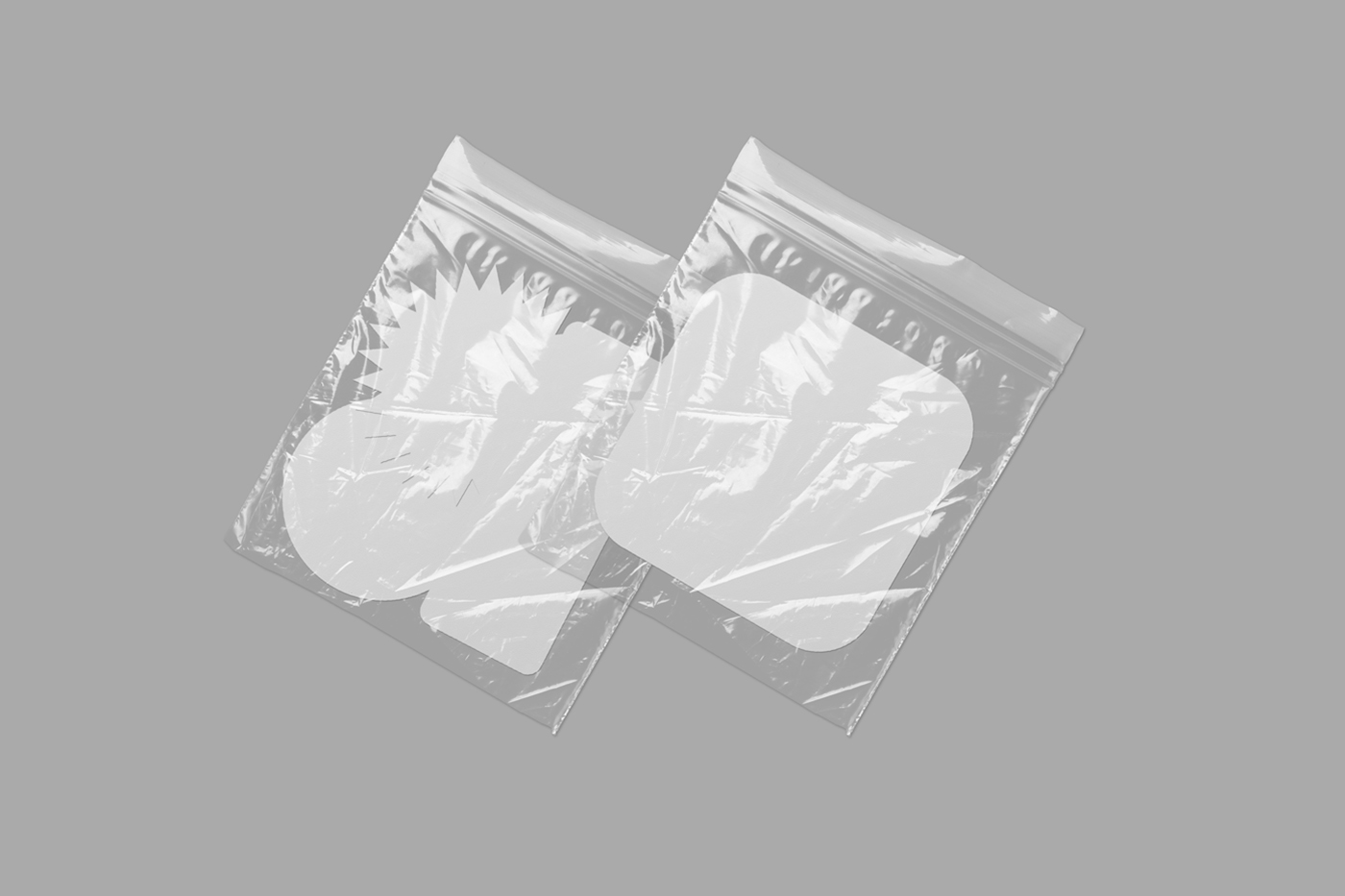 Four custom shape blank sticker mockup in two transparent foils laying on the gray background.