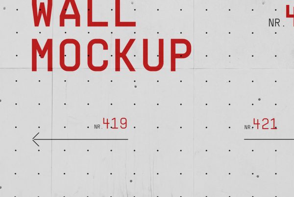 Front view, concrete wall mockup with red typography design against asphalt pavement.