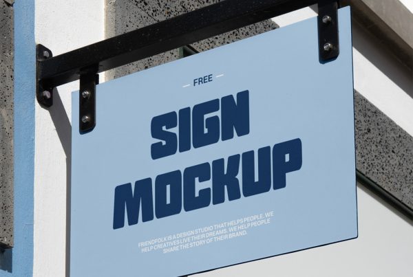 Front view, sign mockup attached to black metal construction hanging in front of the buildings.