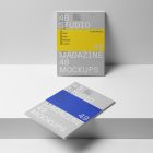 Two a4 gray magazines with minimal design on white stairs from studio magazine mockup.