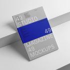 Gray a4 magazine on white cubes from studio magazine mockup.