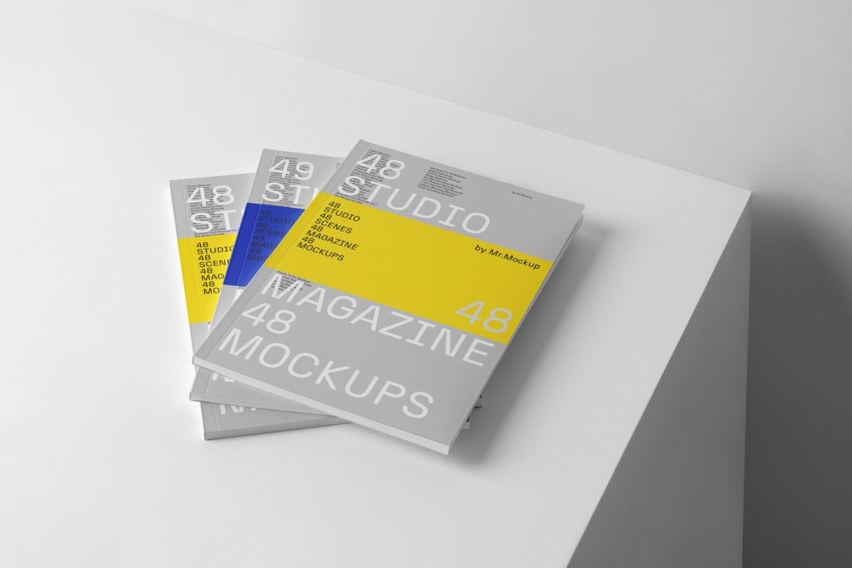 Three gary magazine with minimal design on cube from studio magazine mockups.