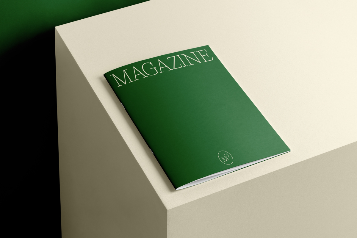 Green thin magazine with elegant design on cube from studio magazine mockups.